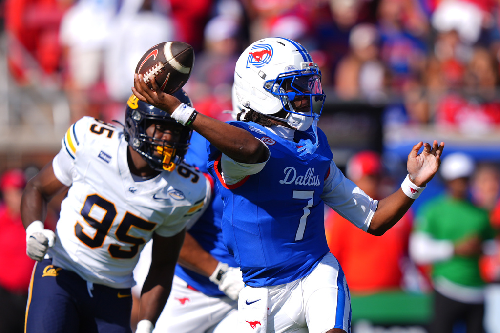 SMU quarterback Kevin Jennings (7) throws a pass as California linebacker JD McKinley (95) pressures during the first half of an NCAA college football game, Saturday, Oct. 24, 2026, in Dallas. (AP Photo/LM Otero)