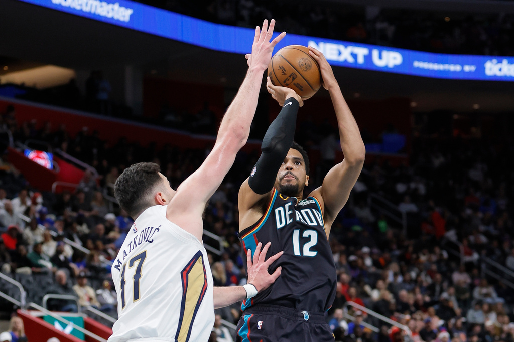 Detroit Pistons forward Tobias Harris (12) takes a shot against New Orleans Pelicans forward Karlo Matkovic (17) during the first half of an NBA basketball game Thursday, March 26, 2026, in Detroit. (AP Photo/Duane Burleson)