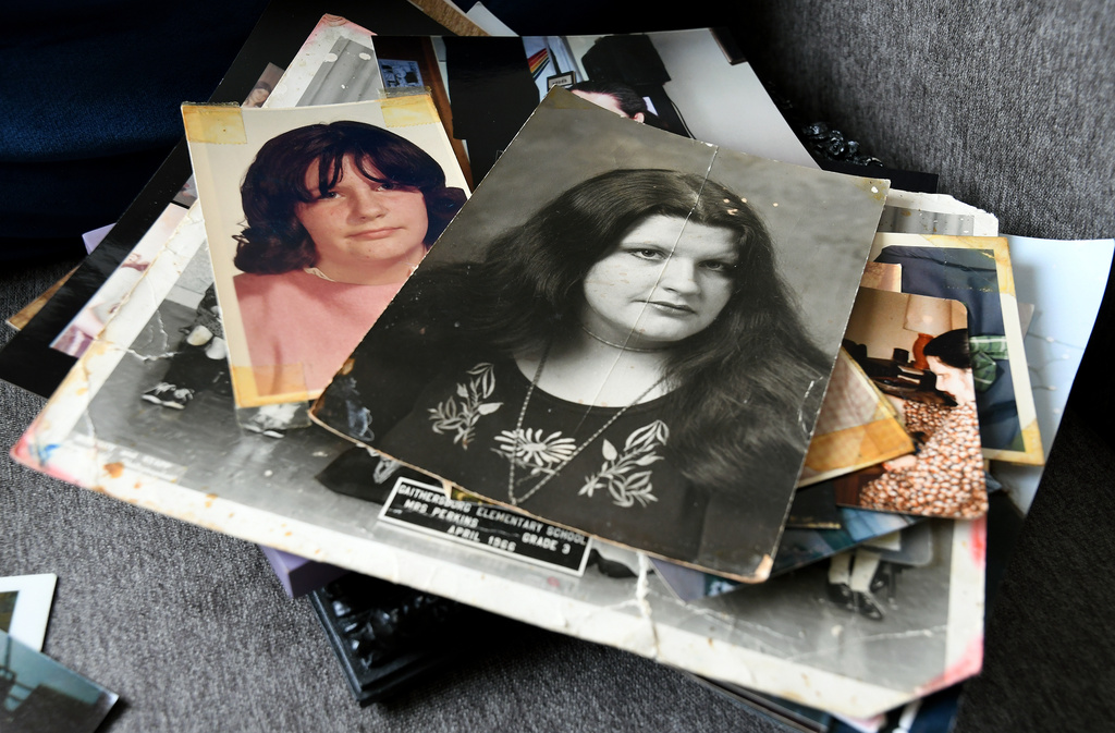 Photographs of Ellen Marie Shriver-Lopes, whose body was one of 189 left to decay in the Return to Nature Funeral Home in Penrose, Colo., are stacked in her sister's home in Colorado Springs, Colo., on Thursday, Feb. 5, 2026. (AP Photo/Thomas Peipert)
