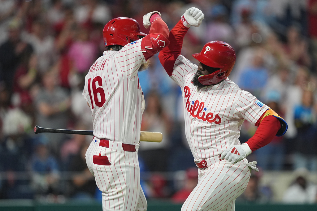 Philadelphia Phillies' Adolis García, right, celebrates his home run off of Washington Nationals pitcher Zack Littell with teammate Brandon Marsh during the fourth inning of a baseball game, Tuesday, March 31, 2026, in Philadelphia. (AP Photo/Matt Rourke)