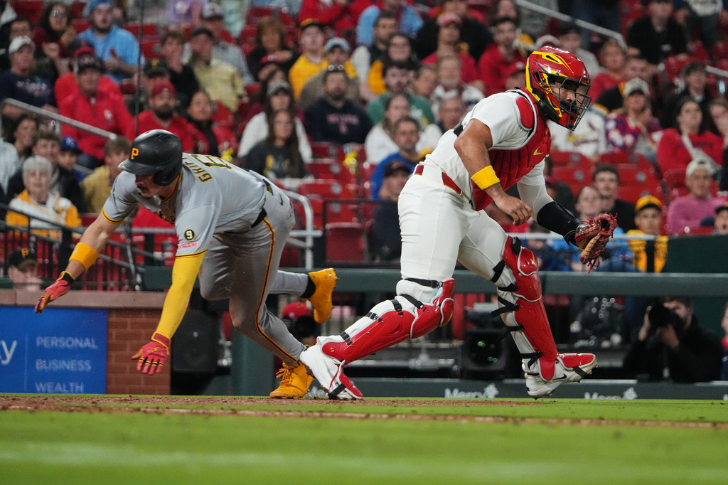 Pittsburgh Pirates' Konnor Griffin, left, scores past St. Louis Cardinals catcher Ivan Herrera during the sixth inning of a baseball game Wednesday, May 20, 2026, in St. Louis. (AP Photo/Jeff Roberson)