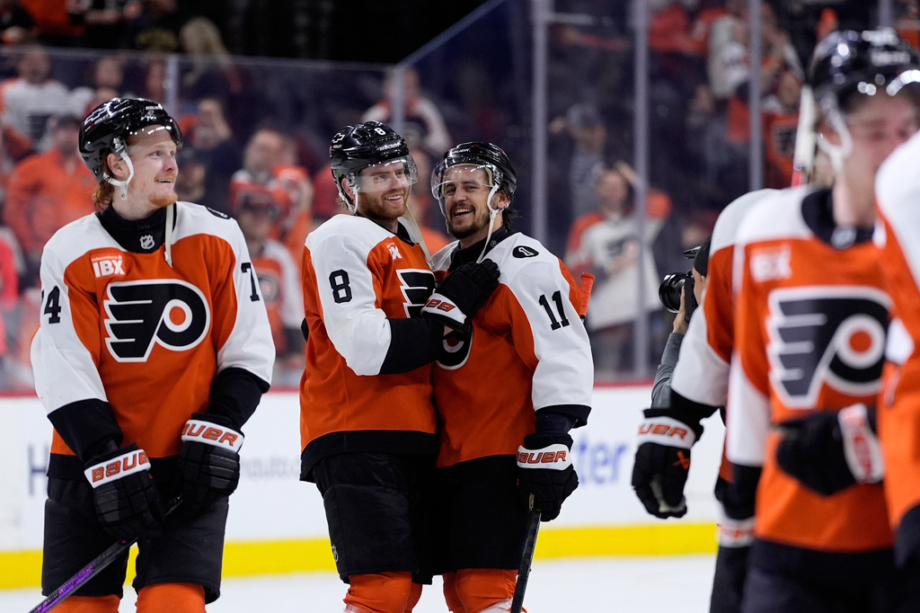 Philadelphia Flyers' Cam York (8) and Travis Konecny (11) celebrate after the Flyers won Game 6 against the Pittsburgh Penguins in the first round of the NHL hockey Stanley Cup playoffs series Wednesday, April 29, 2026, in Philadelphia. (AP Photo/Matt Slocum)