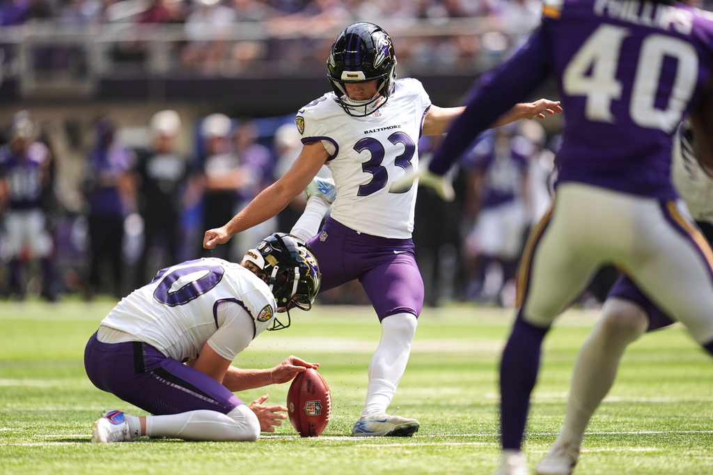 Baltimore Ravens place kicker Tyler Loop (33), with punter Ryan Eckley holding, kicks a 20-yard field goal during the second half of an NFL preseason football game against the Minnesota Vikings, Saturday, Aug. 22, 2026, in Minneapolis. (AP Photo/Abbie Parr)