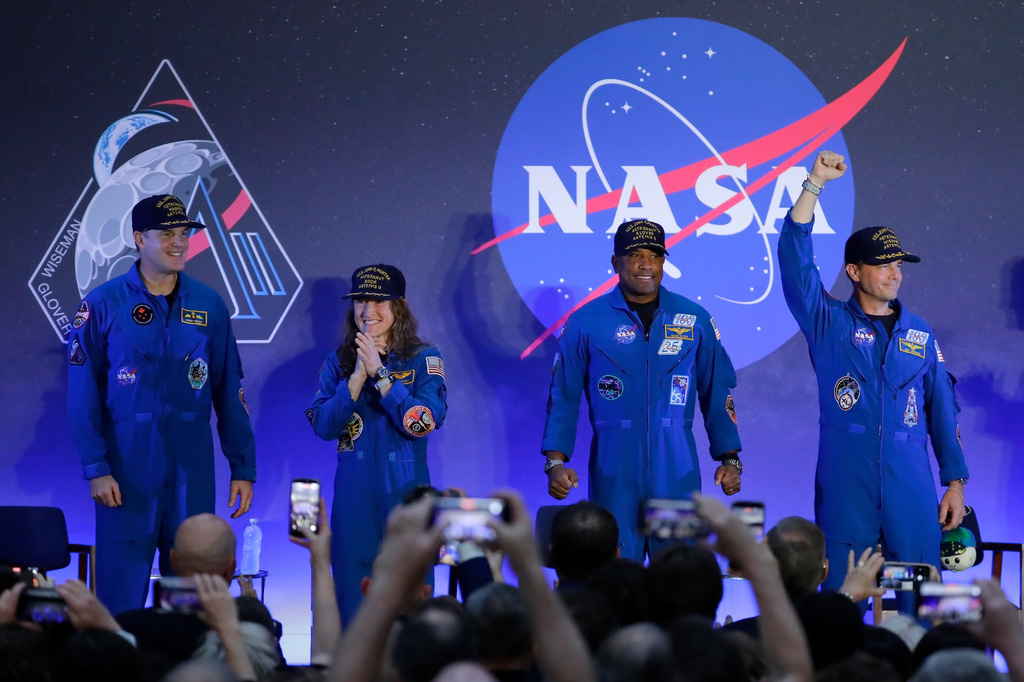 The Artemis II crew, from left, Jeremy Hansen, Christina Koch, Victor Glover and Reid Wiseman acknowledge the crowd as they take the stage during a crew return event Saturday, April 11, 2026, at Ellington Airforce Base in Houston. (AP Photo/Michael Wyke)