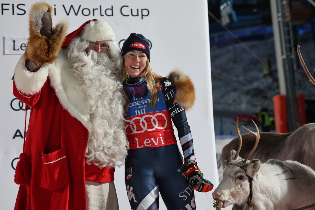FILE - United States' Mikaela Shiffrin poses with Santa Claus as she celebrates on the podium after winning an alpine ski, women's World Cup slalom, in Levi, Finland, on Nov. 15, 2025. (AP Photo/Marco Trovati, File)