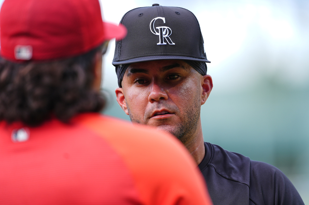 Colorado Rockies infielder Vimael Machin, right, talks with St. Louis Cardinals bullpen catcher Kleininger Teran, left, before a baseball game Saturday, Sept. 5, 2026, in Denver. (AP Photo/David Zalubowski)