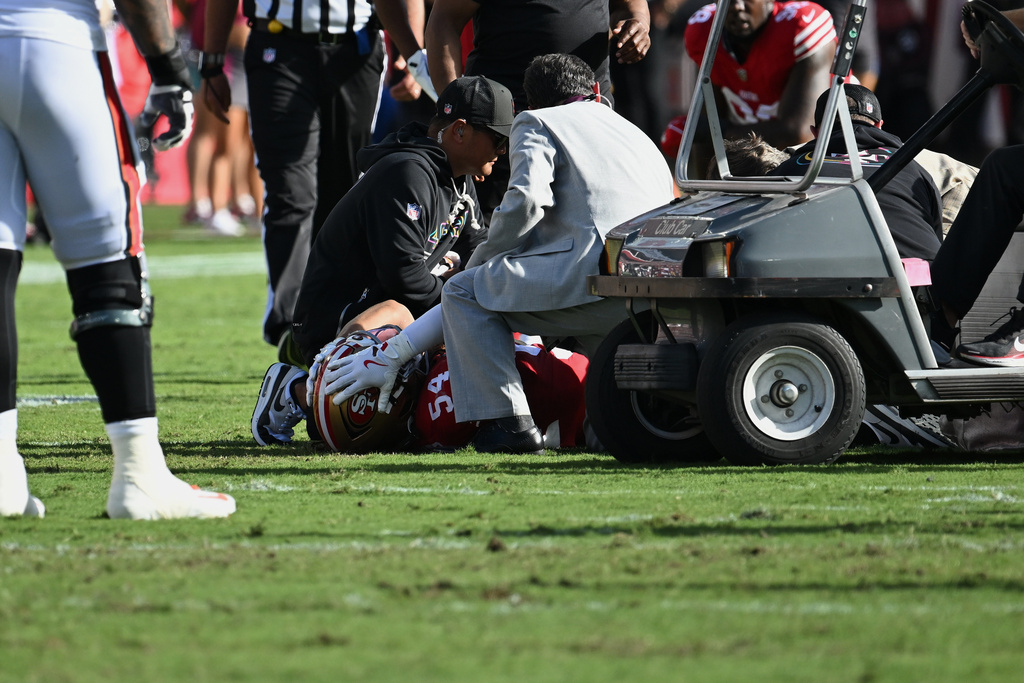 San Francisco 49ers middle linebacker Fred Warner (54) is tended to after being injured during the first half of an NFL football game against the Tampa Bay Buccaneers in Tampa, Fla., Sunday, Oct. 12, 2025. (AP Photo/Jason Behnken)