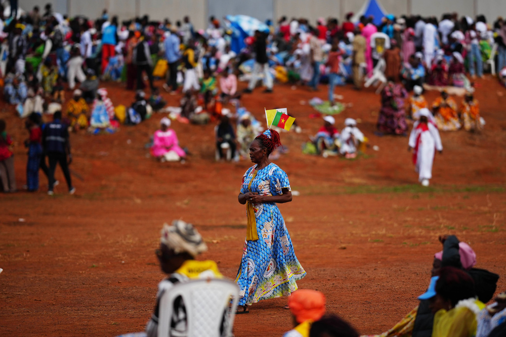 People wait for Pope Leo XIV at Yaounde Ville Airport, Cameroon, Saturday, April 18, 2026 on the sixth day of his 11-day pastoral visit to Africa. (AP Photo/Andrew Medichini)