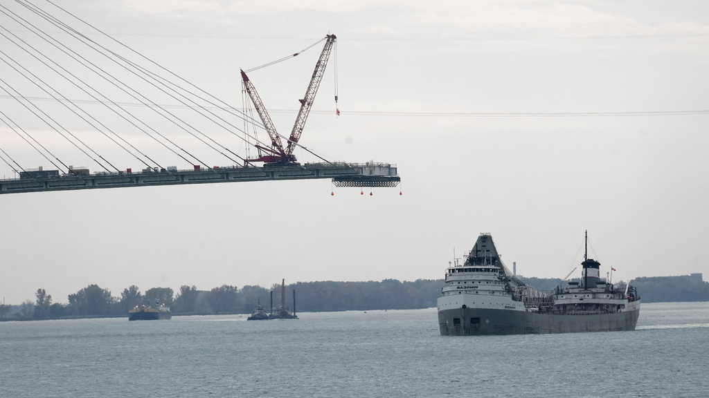 FILE - The Saginaw passes construction on the Gordie Howe International Bridge connecting on the Detroit River connecting Windsor, Ontario and Detroit, Oct. 25, 2023. (AP Photo/Paul Sancya, File)
