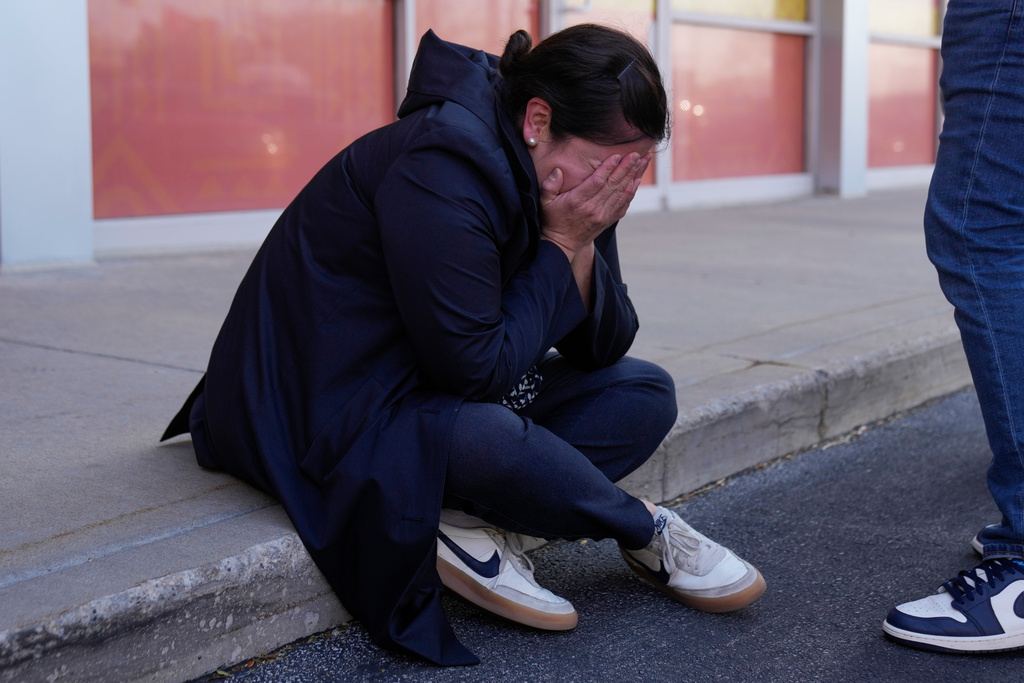 Maria Guzman, a parent of young children, is emotional after speaking outside of Rayito de Sol Spanish Immersion Early Learning Center after an employee of the preschool was arrested by federal immigration agents, Wednesday, Nov. 5, 2025, in Chicago. (AP Photo/Erin Hooley)