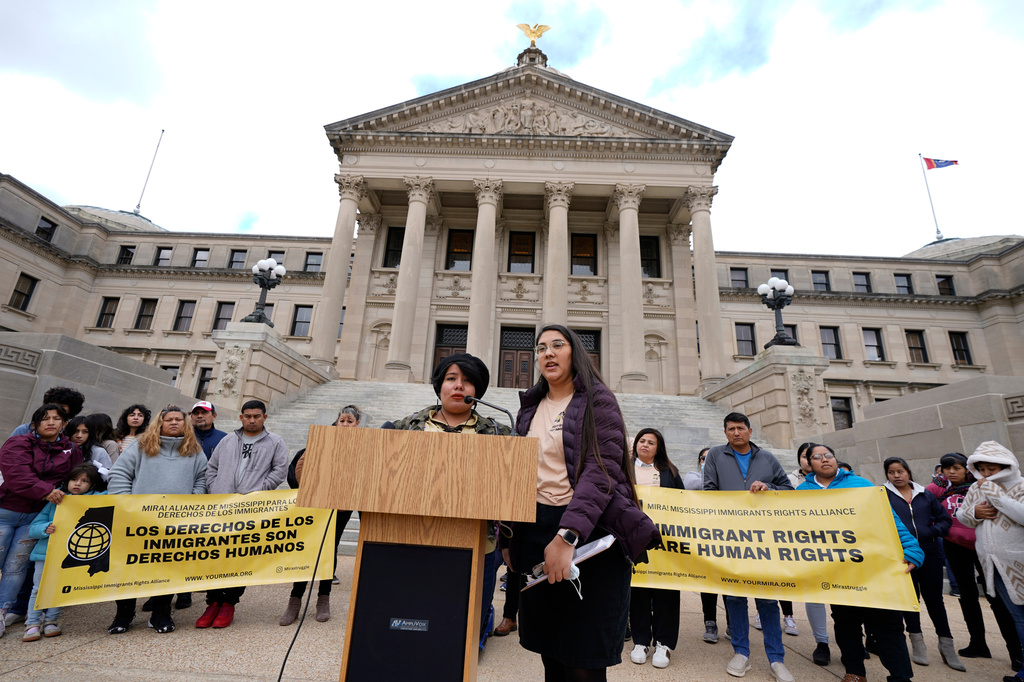 FILE - Yaritza Herrera, left, a young mother in central Mississippi, speaks about her concerns regarding legislative proposals affecting immigrants and migrants, as Loida Ventura Paz of the Mississippi Immigrants' Rights Alliance translates from Spanish to English, during a news briefing before entering the Mississippi Capitol and lobbying lawmakers about those proposals, in Jackson, Wednesday, Jan. 25, 2023. (AP Photo/Rogelio V. Solis, File)