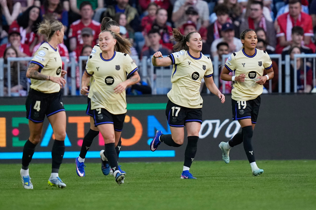 Barcelona's Ewa Pajor, second from right, celebrates after scoring the opening goal during the Women's Champions League semifinal first leg soccer match between Bayern Munich and Barcelona in Munich, Germany, Saturday, April 25, 2026. (AP Photo/Matthias Schrader)