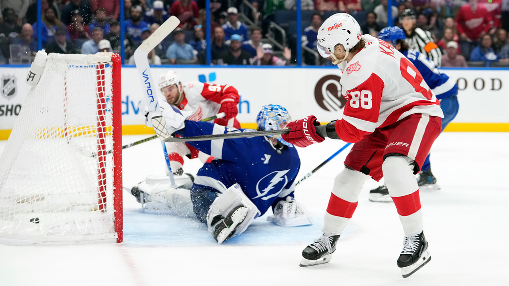 Detroit Red Wings right wing Patrick Kane (88) assists on a goal by right wing Alex DeBrincat (93) against Tampa Bay Lightning goaltender Andrei Vasilevskiy (88) during the third period of an NHL hockey game Monday, April 13, 2026, in Tampa, Fla. (AP Photo/Chris O'Meara)