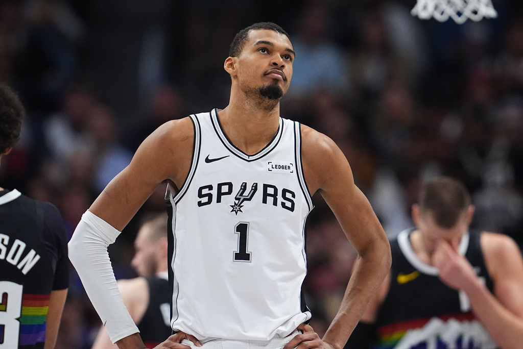 San Antonio Spurs center Victor Wembanyama reacts after being called for his second personal foul in the first half of an NBA basketball game against the Denver Nuggets, Saturday, April 4, 2026, in Denver. (AP Photo/David Zalubowski)