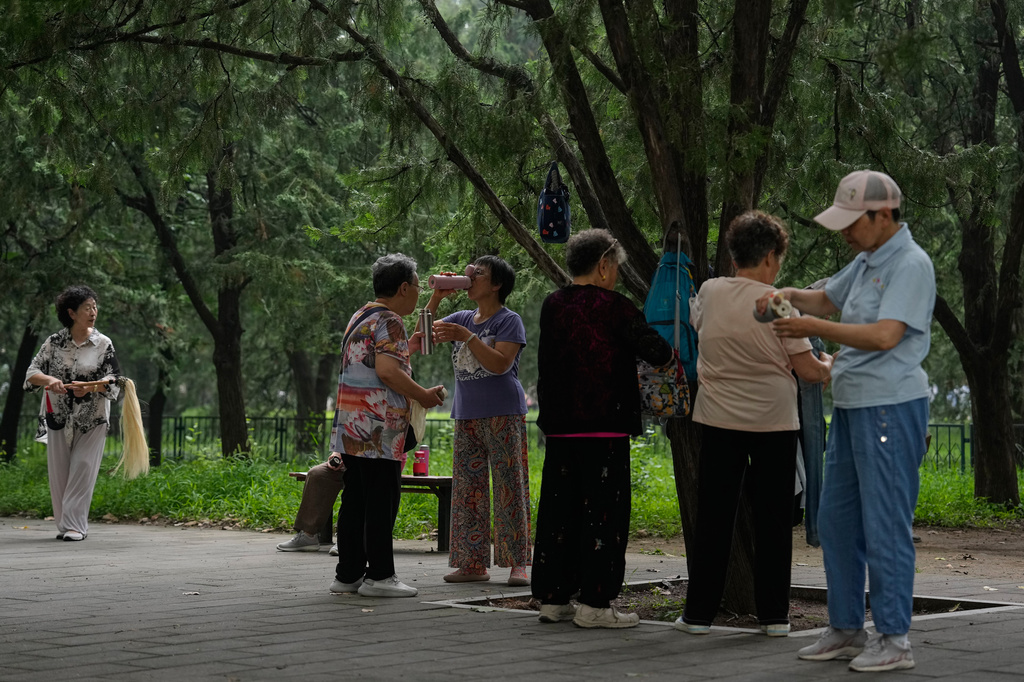 Women drink after practicing Tai Chi at a park near the Temple of Heaven in Beijing, Thursday July 9, 2026. (AP Photo/Andy Wong)