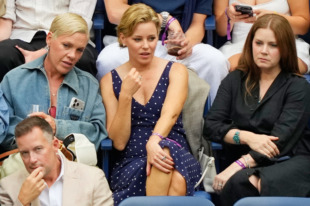 Pink, from left, Elizabeth Banks and Amy Adams attend a match between Aryna Sabalenka, of Belarus, and Elena Rybakina, of Kazakhstan, during the women's singles final of the U.S. Open tennis championships Saturday, Sept. 12, 2026, in New York. (AP Photo/Yuki Iwamura)