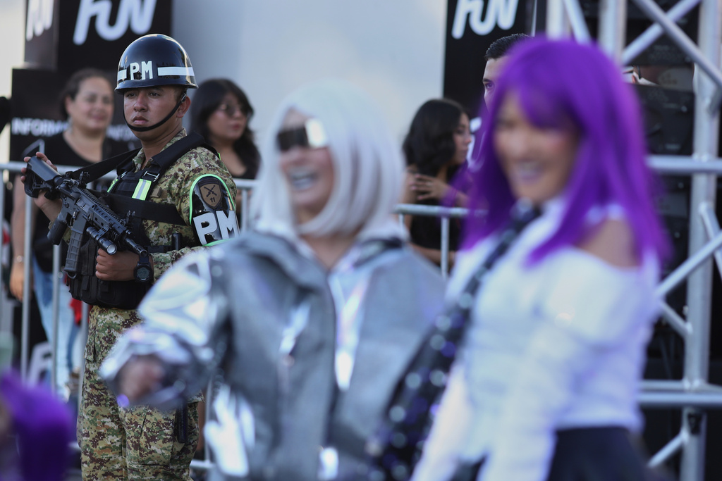 A soldier stands by fans of Colombian pop star Shakira before her concert at the National Stadium in San Salvador, El Salvador, Thursday, Feb. 12, 2026. (AP Photo/Salvador Melendez)