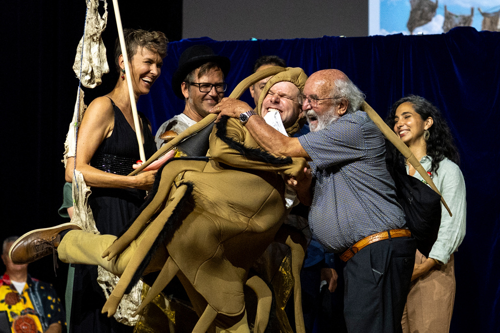 Soil Science Prize Winners, from left, Pia Viviani, Franz Bender, Marcel van der Heijden and Atlant Bieri, receive their prize from Nobel Prize winner Michel Major during the Ig Nobel Prize ceremony held in the Zurich Convention Center in Zurich, Switzerland, on Thursday, Sept. 3, 2026. (Claudio Thoma/Keystone via AP)