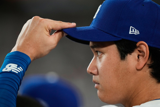 Los Angeles Dodgers' Shohei Ohtani watches from the dugout during the fifth inning in Game 1 of the National League Wild Card baseball playoff series against the Cincinnati Reds, Tuesday, Sept. 30, 2025, in Los Angeles. (AP Photo/Mark J. Terrill) Los Angeles Dodgers' Shohei Ohtani watches from the dugout during the fifth inning in Game 1 of the National League Wild Card baseball playoff series against the Cincinnati Reds, Tuesday, Sept. 30, 2025, in Los Angeles. (AP Photo/Mark J. Terrill)