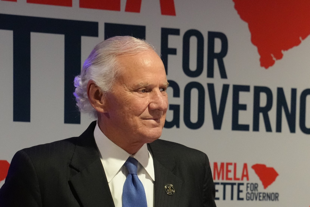 South Carolina Gov. Henry McMaster looks on as Lt. Gov. Pamela Evette speaks at an election night watch party after advancing to a GOP primary runoff in the governor's race on Tuesday, June 9, 2026, in Greenville, S.C. (AP Photo/Meg Kinnard)