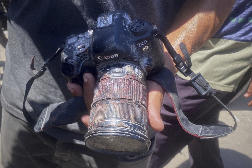 In this family handout photo, a person shows the blood-stained camera that freelance journalist Mariam Dagga, 33, was carrying when she was killed in a double Israeli strike on Nasser Hospital in Khan Younis, southern Gaza Strip, Monday, Aug. 25, 2025. (Family Handout via AP)