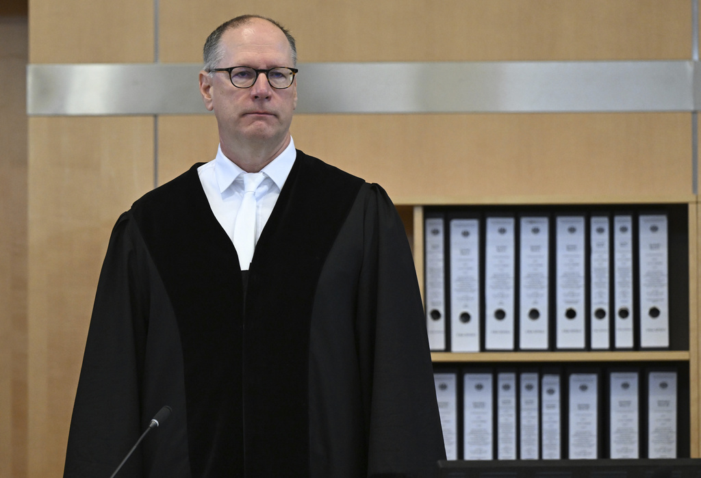 The presiding judge Winfried van der Grinten stands in the courtroom at the start of the hearing of the 27-year-old man who is alleged to have stabbed three people to death at the city festival "Festival of Diversity", in Duesseldorf, Germany, Wednesday Sept. 10, 2025. (Federico Gambarini/dpa via AP)