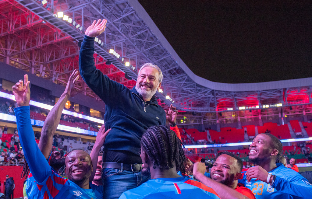 Congo national team members celebrate with their coach Sebastien Desabre after being qualified for the FIFA 2026 soccer World Cup in the African qualifier final match against Nigeria, in Rabat, Morocco, Sunday, Nov. 16, 2025. (AP Photo)