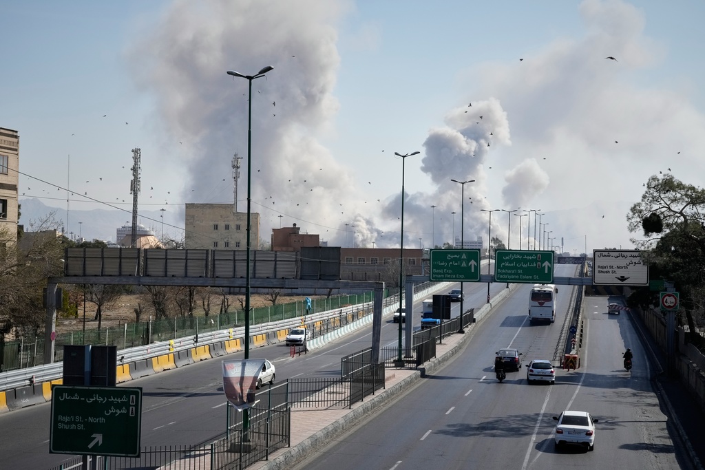 FILE - Plumes of smoke rise as strikes hit the city during the U.S.–Israeli military campaign in Tehran, Iran, March 5, 2026. (AP Photo/Vahid Salemi, File)