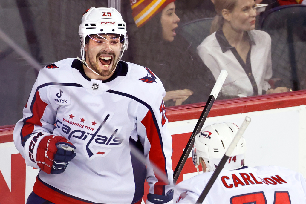 Washington Capitals' Hendrix Lapierre, left, celebrates after his goal against the Calgary Flames with John Carlson, right, during second-period NHL hockey game action in Calgary, Alberta, Friday, Jan. 23, 2026. (Larry MacDougal/The Canadian Press via AP)