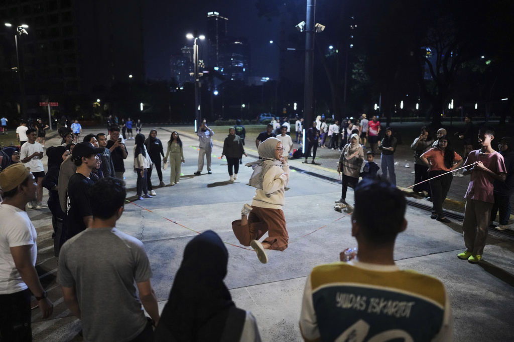 A participant plays jump rope during a community playing gathering in Jakarta, Indonesia, Friday, July 11, 2025. (AP Photo/Dita Alangkara)