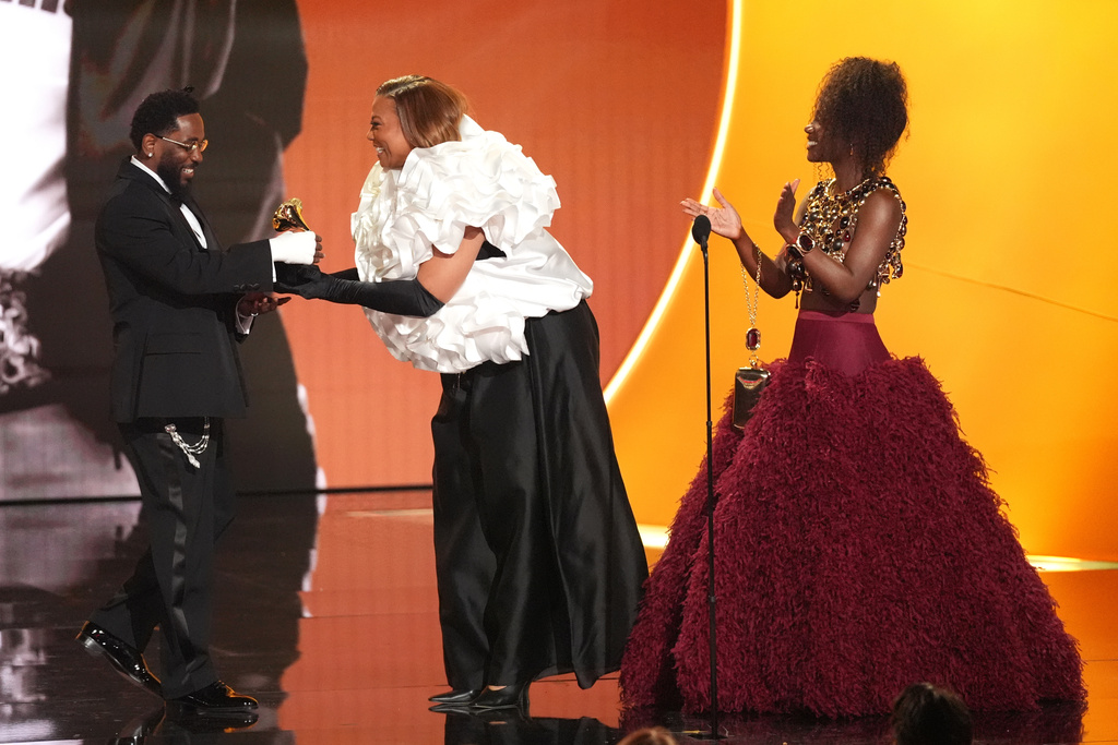 Kendrick Lamar, left, accepts the award for best rap album for "GNX" from Queen Latifah, and Doechii during the 68th annual Grammy Awards on Sunday, Feb. 1, 2026, in Los Angeles. (AP Photo/Chris Pizzello)