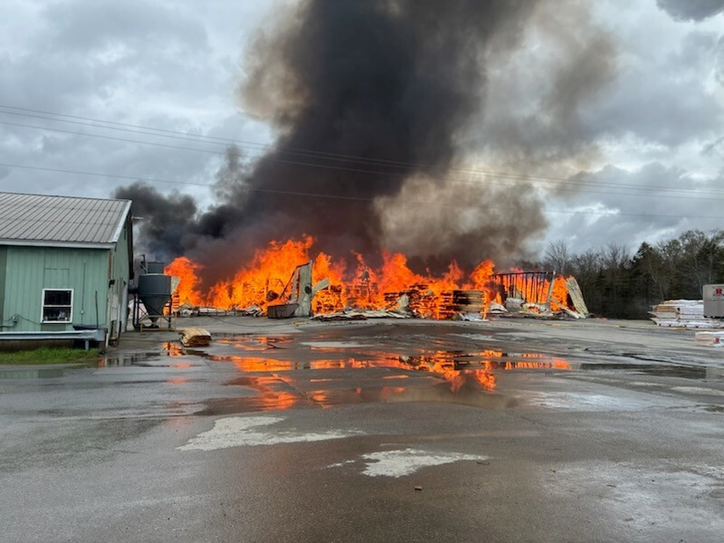 This photo provided by the Maine Department of Public Safety shows flames from a large fire at Robbins Lumber in Searsmont, Maine on Friday, May 15, 2026 (Maine Department of Public Safety via AP)