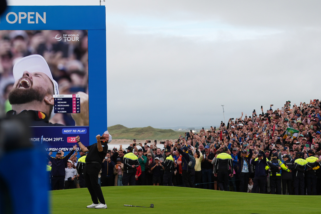 Shane Lowry of Ireland, center, celebrates winning the Irish Open golf tournament at Trump International Golf Links in Doonbeg, Ireland, Sunday, Sept. 13, 2026. (AP Photo/Julia Demaree Nikhinson)