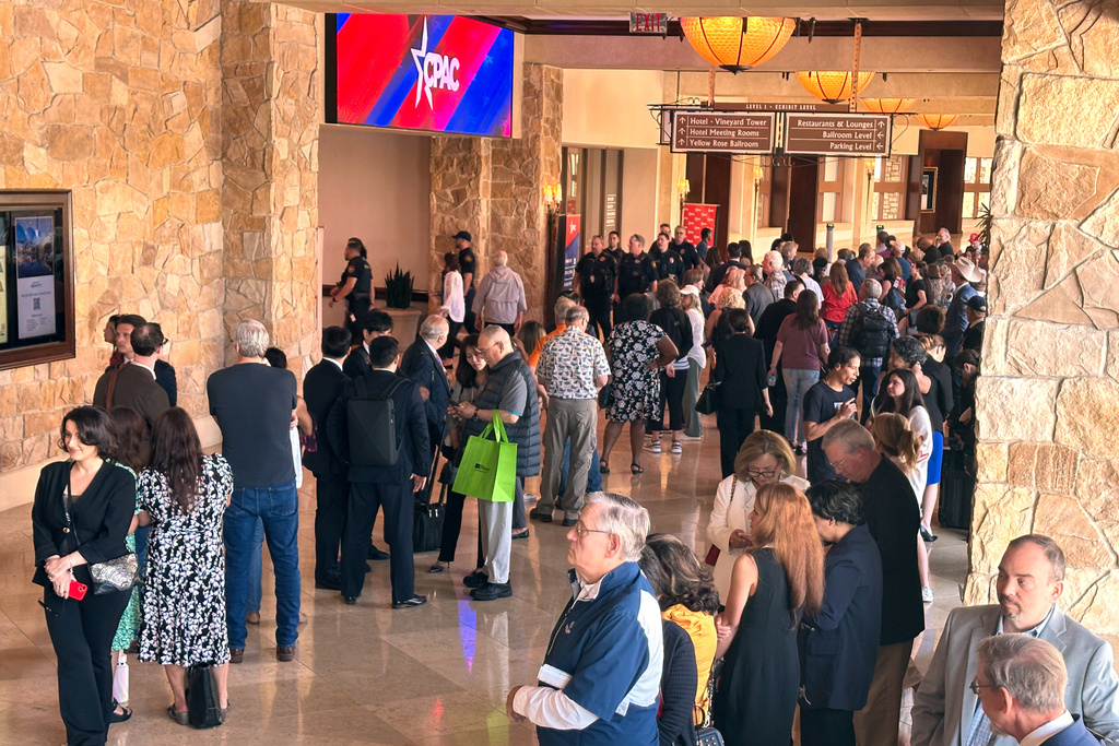 Attendees wait in line to enter the Conservative Political Action Conference in Grapevine, Texas, Wednesday, March 25, 2026, as the annual gathering of thousands of conservatives from around the country and overseas begins. (AP Photo/Thomas Beaumont)