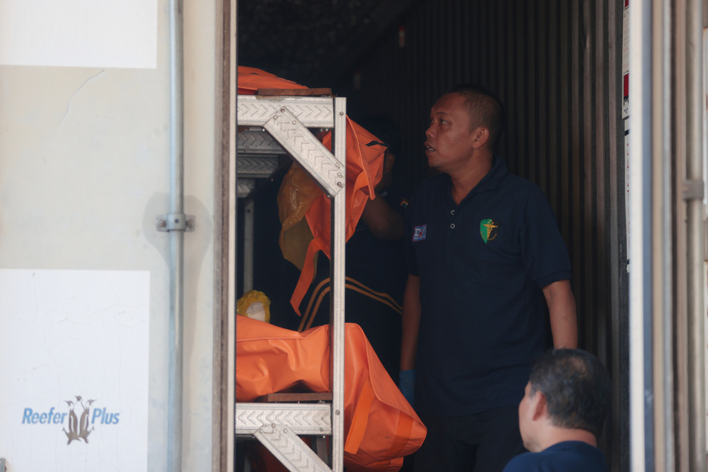 Rescuers arrange the bodies of the victims of a building that collapsed at an Islamic boarding school inside a refrigerated container at the police hospital in Surabaya, East Java, Indonesia, Sunday, Oct. 5, 2025. (AP Photo/Trisnadi)