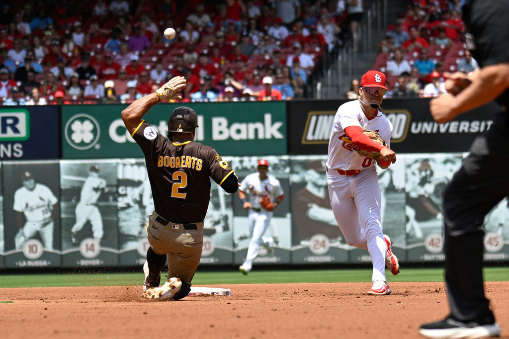 San Diego Padres' Xander Bogaerts slides to second while St. Louis Cardinals' Masyn Winn, right, throws to first during the second inning of a baseball game Wednesday, June 17, 2026, in St. Louis. (AP Photo/Lexie Knight)