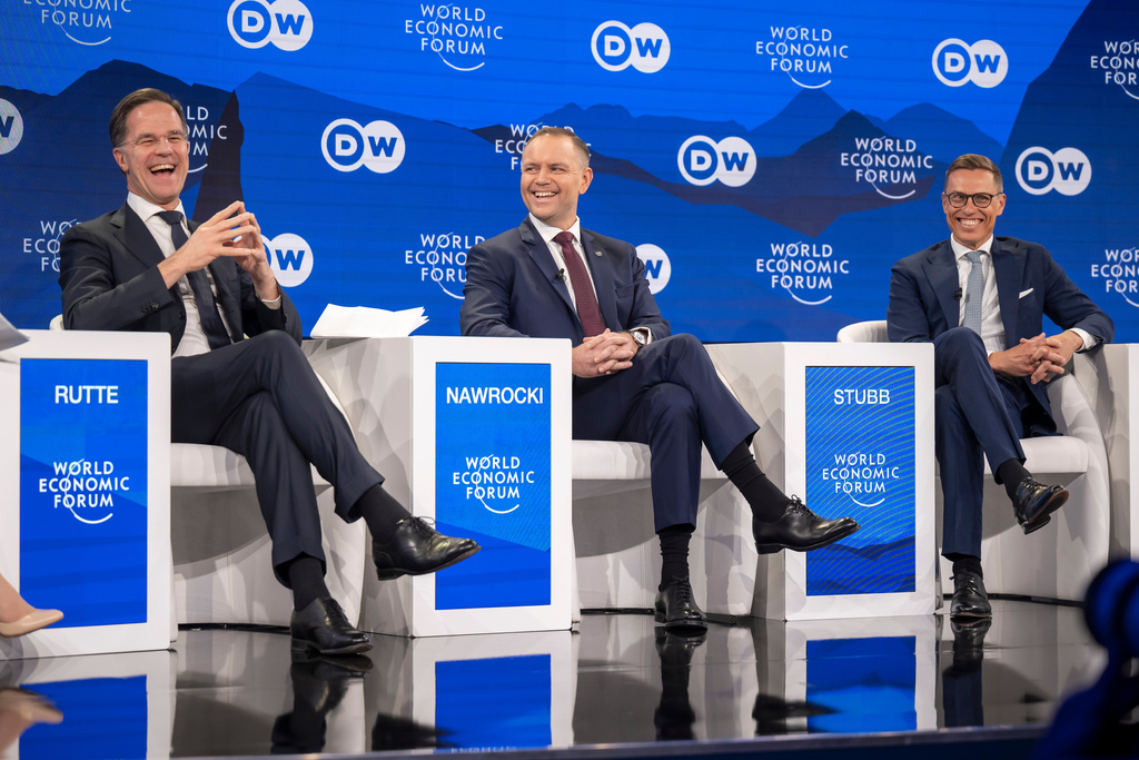 Mark Rutte, left, Secretary-General, North Atlantic Treaty Organization (NATO), Karol Nawrocki, center, President of Poland, and Alexander Stubb, right, President of Finland, speak during a panel discussion during the 56th annual meeting of the World Economic Forum, in Davos, Switzerland, Wednesday, Jan. 21, 2026. (Gian Ehrenzeller/Keystone via AP)