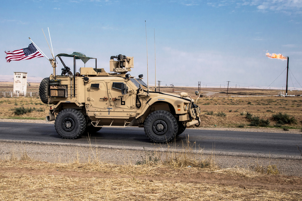 FILE - U.S. forces patrol oil fields in Syria, Oct. 28, 2019 . (AP Photo/Baderkhan Ahmad, File)