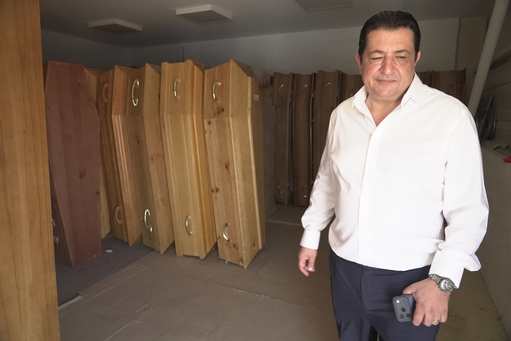 Zouhaeir Hertelli, a mortuary and funeral service director, walks out of his coffin storeroom near Paris’ Orly airport on Sunday, June 28, 2026. (AP Photo/John Leicester)