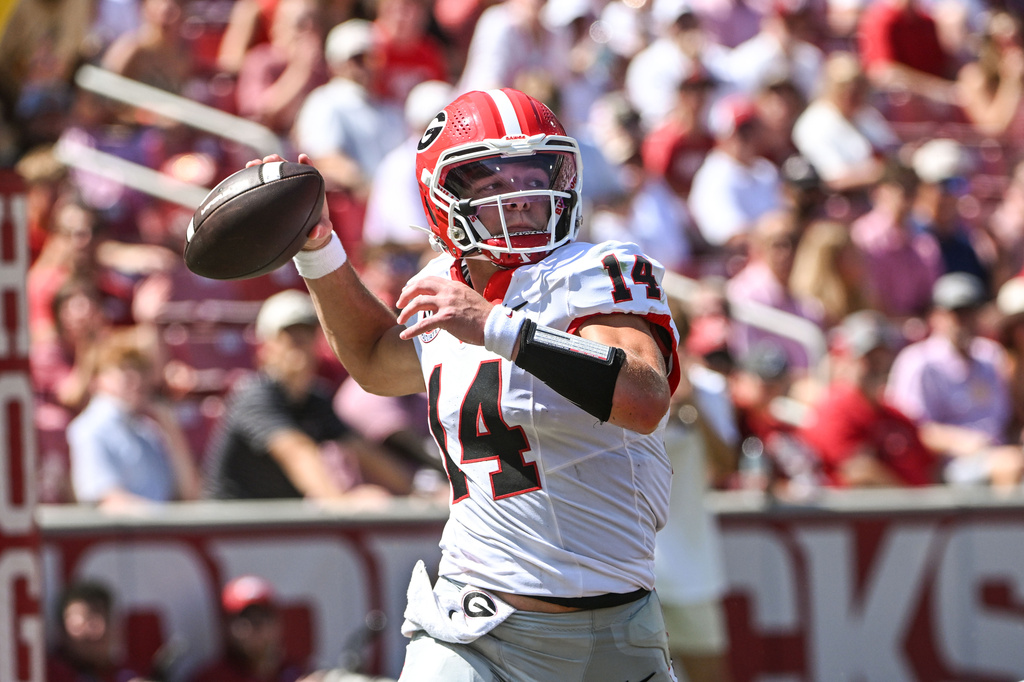 Georgia quarterback Gunner Stockton drops back to throw a pass against Arkansas during an NCAA college football game Saturday, Sept. 19, 2026, in Fayetteville, Ark. (AP Photo/Michael Woods)