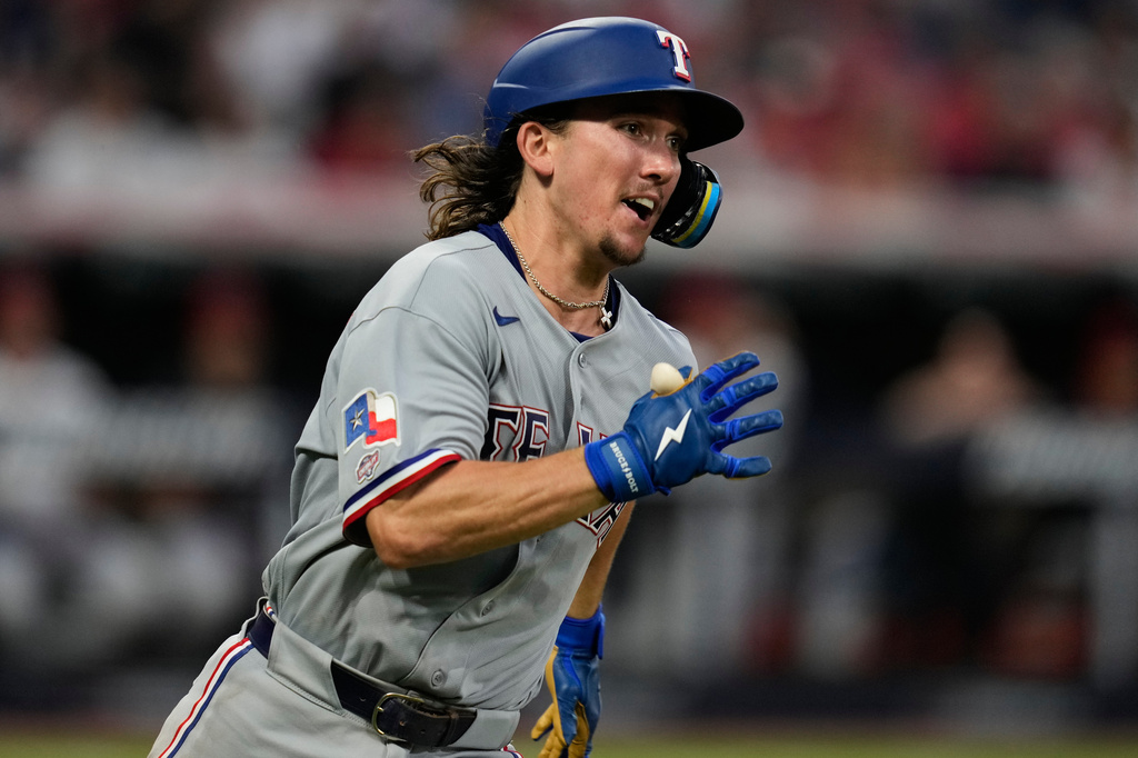 Texas Rangers' Cameron Cauley runs towards first base with a triple, his first major league hit, in the seventh inning of a baseball game against the Cleveland Guardians in Cleveland, Monday, June 29, 2026. (AP Photo/Sue Ogrocki)