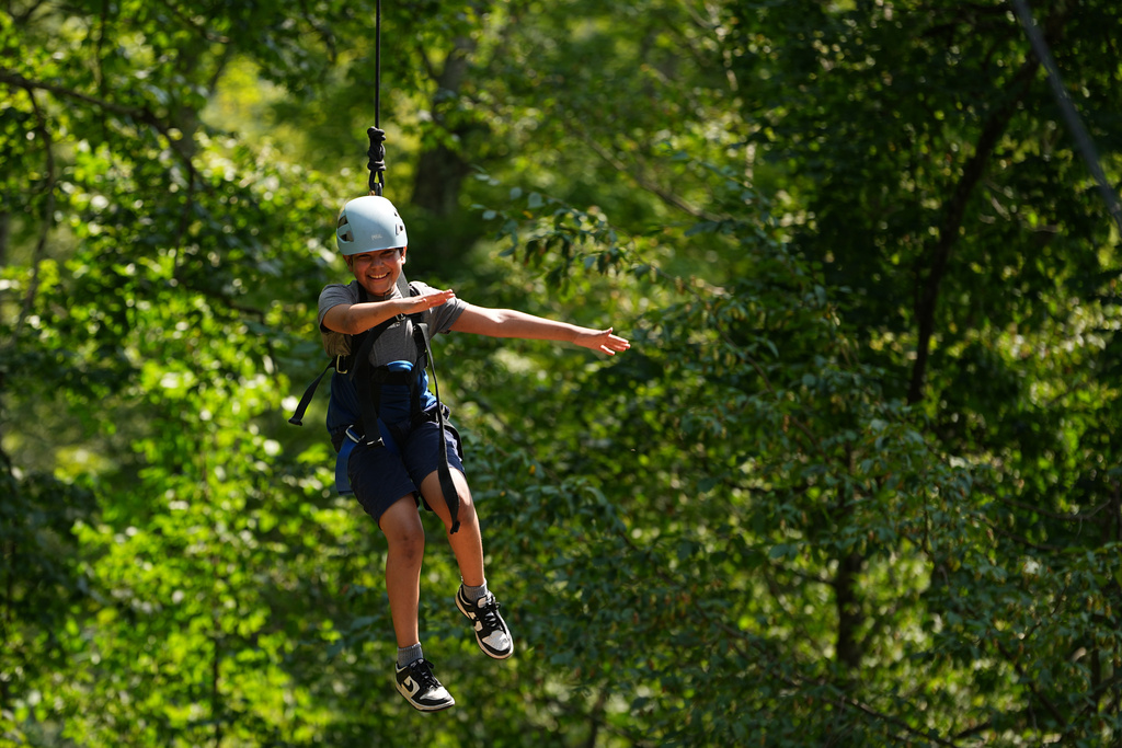 Dylan Aristy Mota, 12, of New York City, who has lupus, is hoisted in the air by fellow campers during an activity at the Frost Valley YMCA sleepaway camp in Claryville, N.Y., Wednesday, July 30, 2025. The camp partnered with Children's Hospital at Montefiore so kids with autoimmune diseases could attend for the first time. (AP Photo/Matt Rourke)