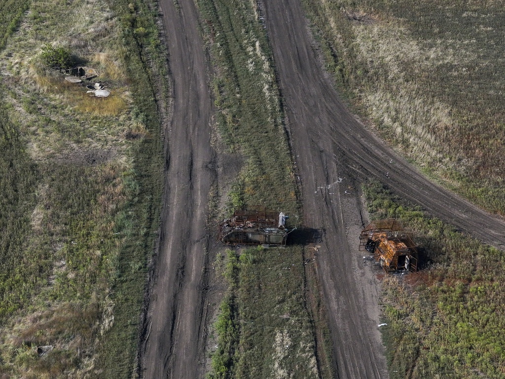 Burned Ukrainian military vehicles are seen on the frontline in the Donetsk region of Ukraine, Wednesday, Sept. 10, 2025. (AP Photo/Alex Babenko)