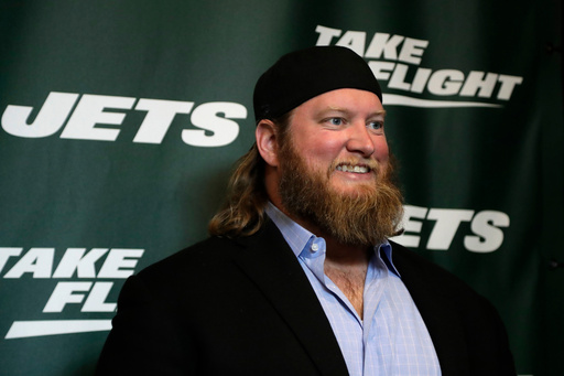 FILE - Former New York Jets center Nick Mangold poses for photographers on the green carpet ahead of an event unveiling the team's new NFL football uniforms, Thursday, April 4, 2019, in New York. (AP Photo/Julio Cortez, File) FILE - Former New York Jets center Nick Mangold poses for photographers on the green carpet ahead of an event unveiling the team's new NFL football uniforms, Thursday, April 4, 2019, in New York. (AP Photo/Julio Cortez, File)