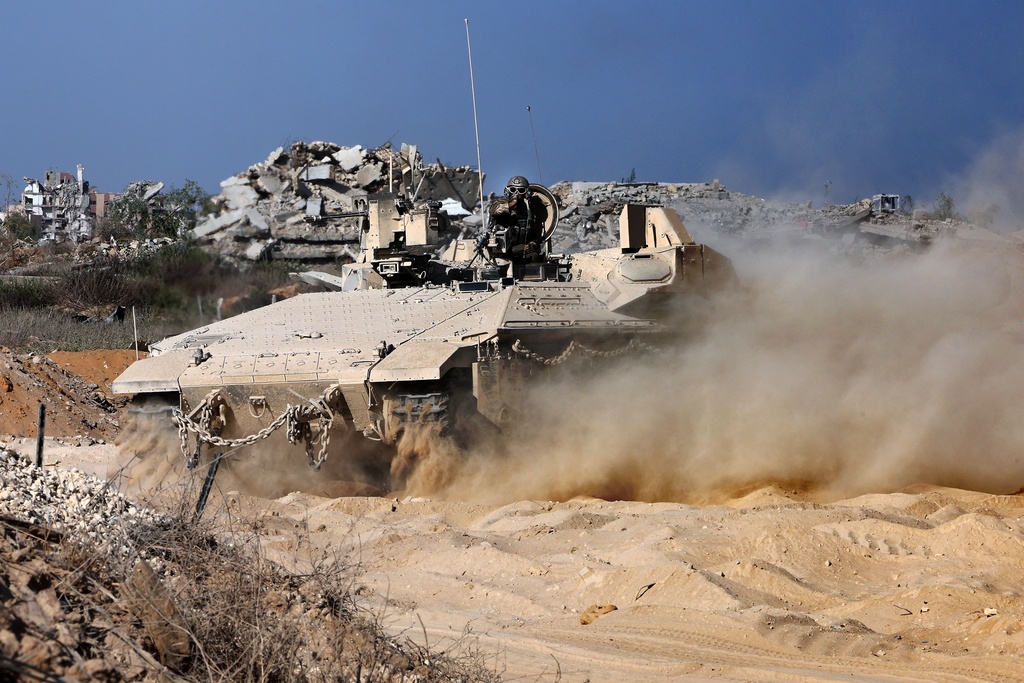 This picture taken during a media tour organised by the Israeli army shows an Israeli army vehicle manoeuvring at a position in the vicinity of the Jordanian Field Hospital in Gaza City, Friday, Oct. 3, 2025. (Jack Guez/Pool Photo via AP)
