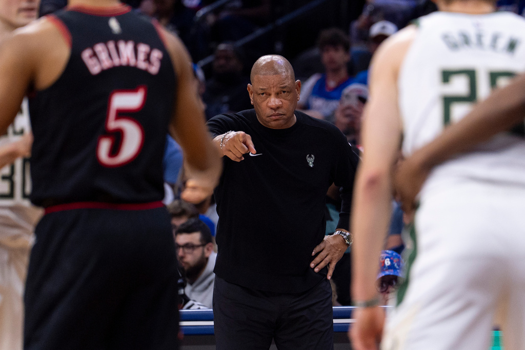 Milwaukee Bucks head coach Doc Rivers, center, directs his team from the sideline during the first half of an NBA basketball game against the Philadelphia 76ers, Sunday, April 12, 2026, in Philadelphia. (AP Photo/Chris Szagola)