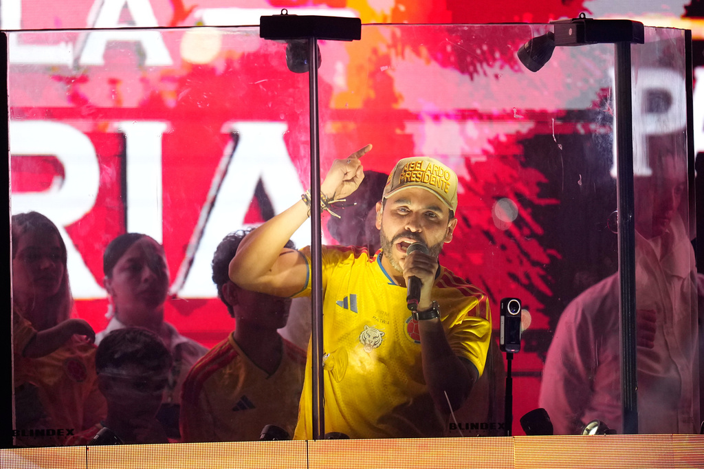 Presidential candidate Abelardo de la Espriella of the Defenders of the Motherland movement addresses supporters from inside a bulletproof booth after leading the first round of the presidential election and advancing to a runoff in Barranquilla, Colombia, Sunday, May 31, 2026. (AP Photo/Fernando Vergara)