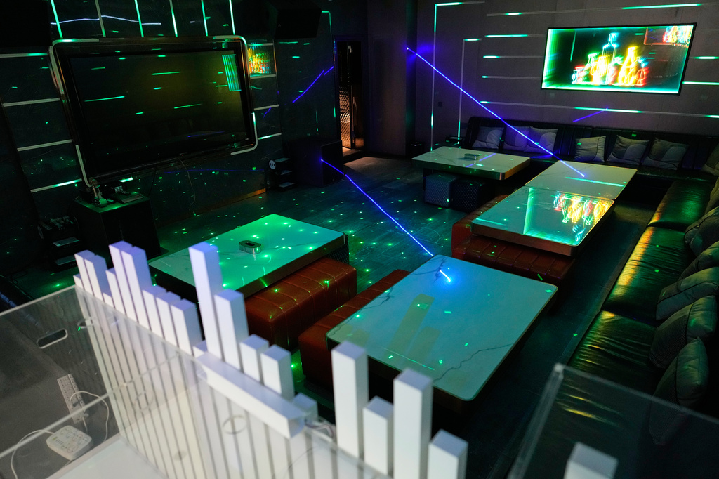 Lights flash in a karaoke room at a former scam compound that is now being used as the Presidential Anti-Organized Crime Commission temporary detention center for rescued scam workers in Pasay, Philippines, Wednesday, June 4, 2025. (AP Photo/Aaron Favila)
