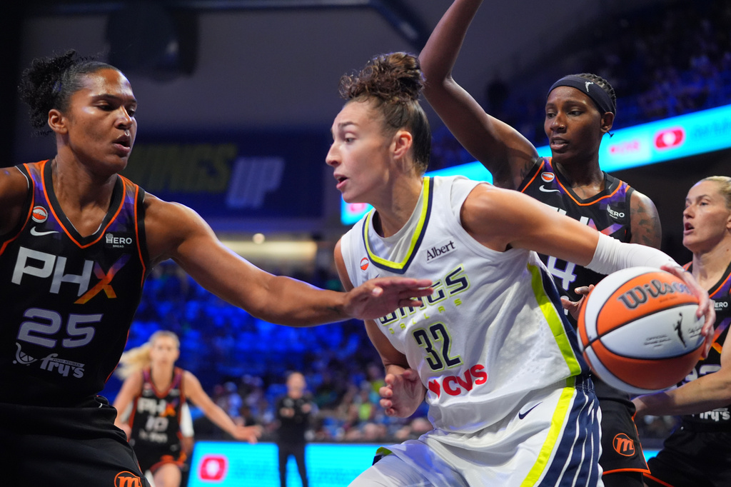 Dallas Wings forward Jessica Shepard (32) drives against Phoenix Mercury defenders Alyssa Thomas (25) and Natasha Mack (4) during the first half of a WNBA basketball game in Arlington, Texas, Saturday, Sept. 19, 2026. (AP Photo/LM Otero)