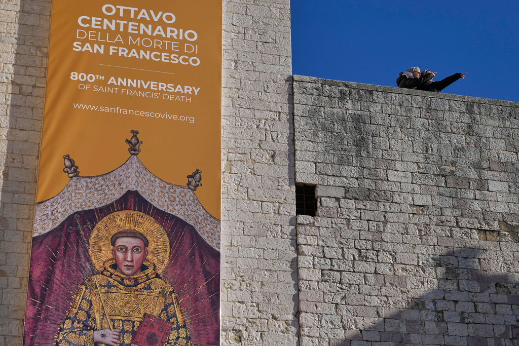 Nuns stand outside the St. Francis Basilica where the bones of the Saint are on the first public display marking the 800th anniversary of his death, in Assisi, Italy, Sunday, Feb. 22, 2026.(AP Photo/Gregorio Borgia)